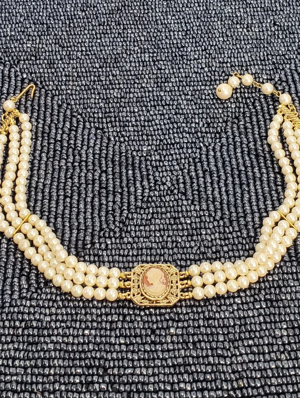 Vintage-style 3-strand pearl choker necklace with a prominent cameo centerpiece